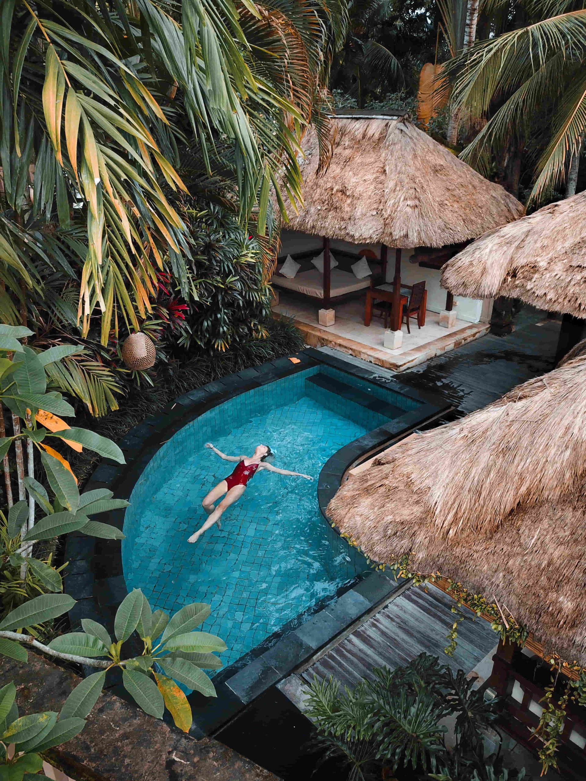 woman relaxing in pool at a jungle resort